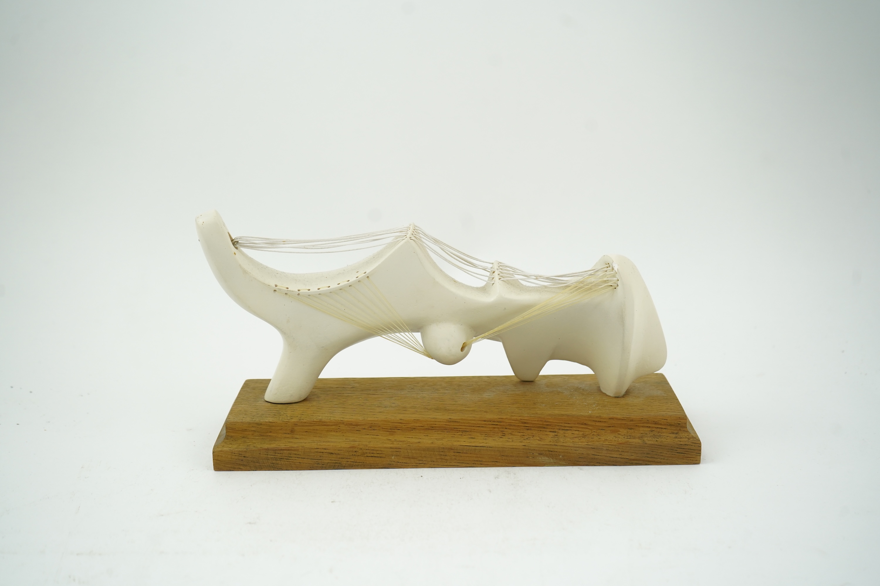 Follower of Henry Moore (1898-1986) A modernist stringed plaster sculpture raised on an oak rectangular plinth base, 25cm wide
